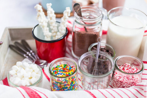 Hot chocolate bar with variety of topping on the tray .