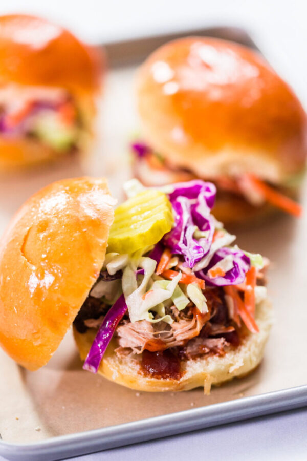 BBQ pulled pork sandwich in shape of small sliders with brioche buns.