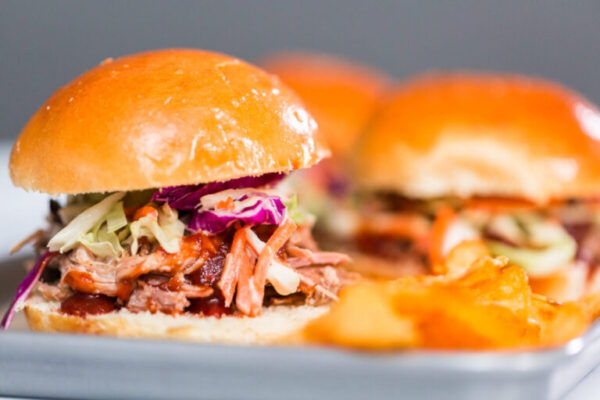 BBQ pulled pork sandwich in shape of small sliders with brioche buns.