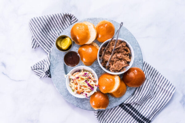 BBQ pulled pork sandwich in shape of small sliders with brioche buns.