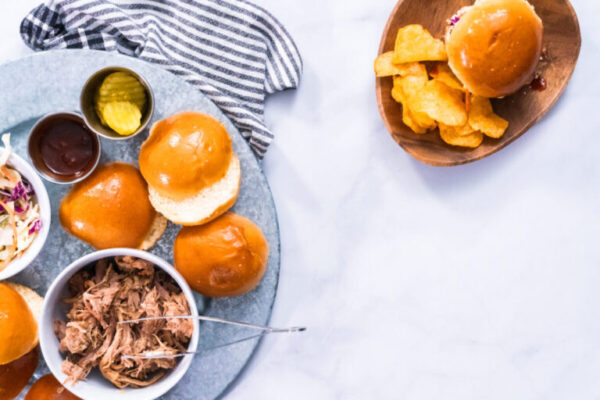 BBQ pulled pork sandwich in shape of small sliders with brioche buns.