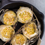 Roasted garlic spread recipe made with spices in cast iron skillet.