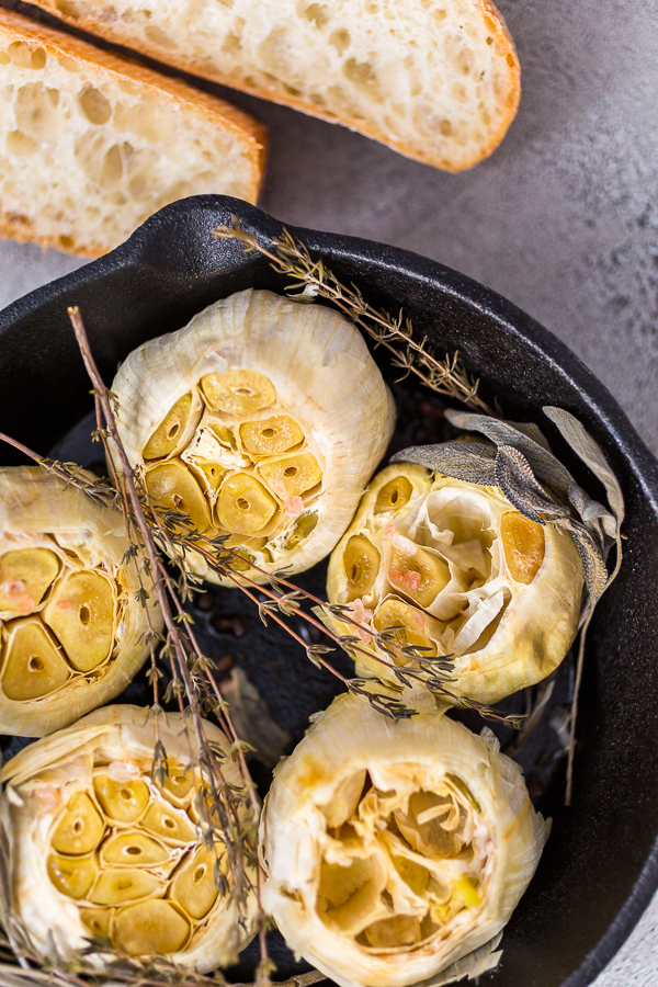 Roasted garlic spread recipe made with spices in cast iron skillet.