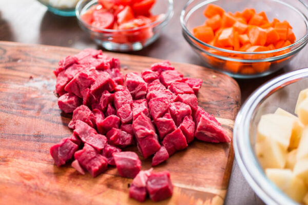Beef sirloin - Arina Photography Cubed beef sirloin on wood cutting board.