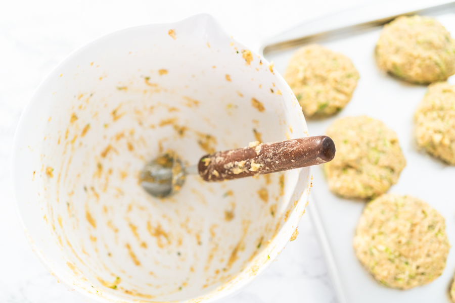 Used bowl with batter remnants and a spoon, showing finished mixing process.