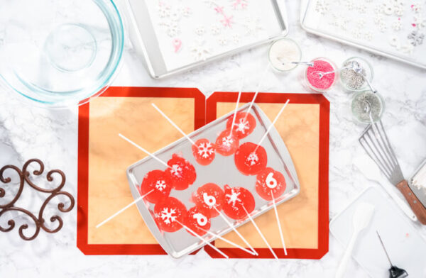 Flat lay. Making homemade berry flavor lollipops with snowflakes.