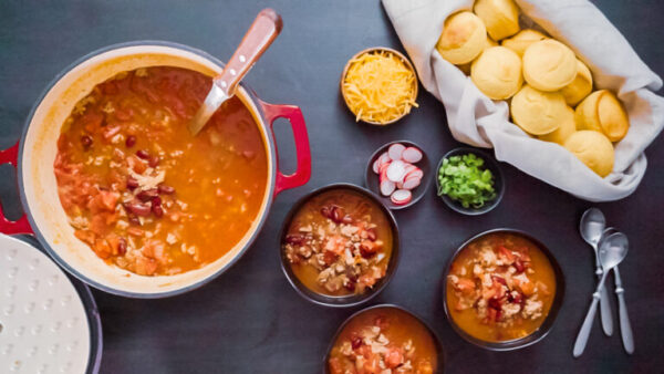 Step by step. Top view. Serving turkey chili from enameled cast iron covered dutch oven.