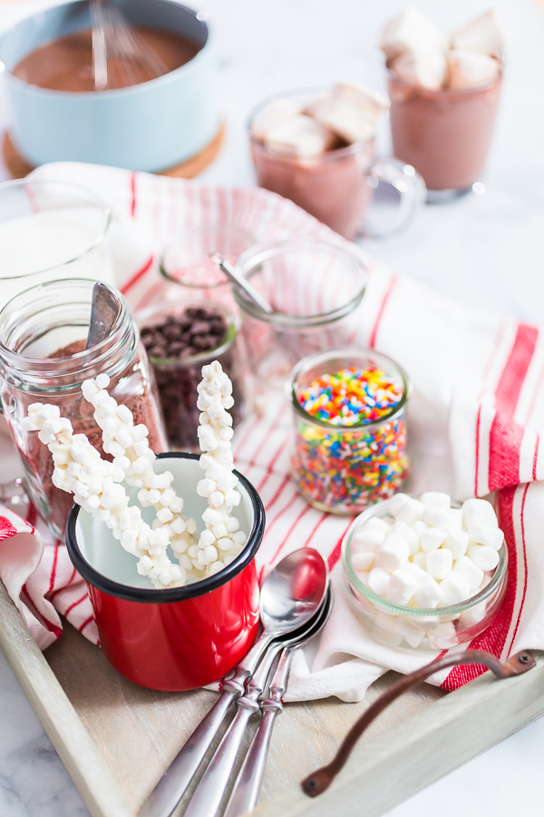 Hot chocolate bar with variety of topping on the tray .