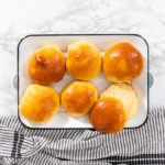 Flat lay. Freshly baked brioche buns on a metal serving tray.