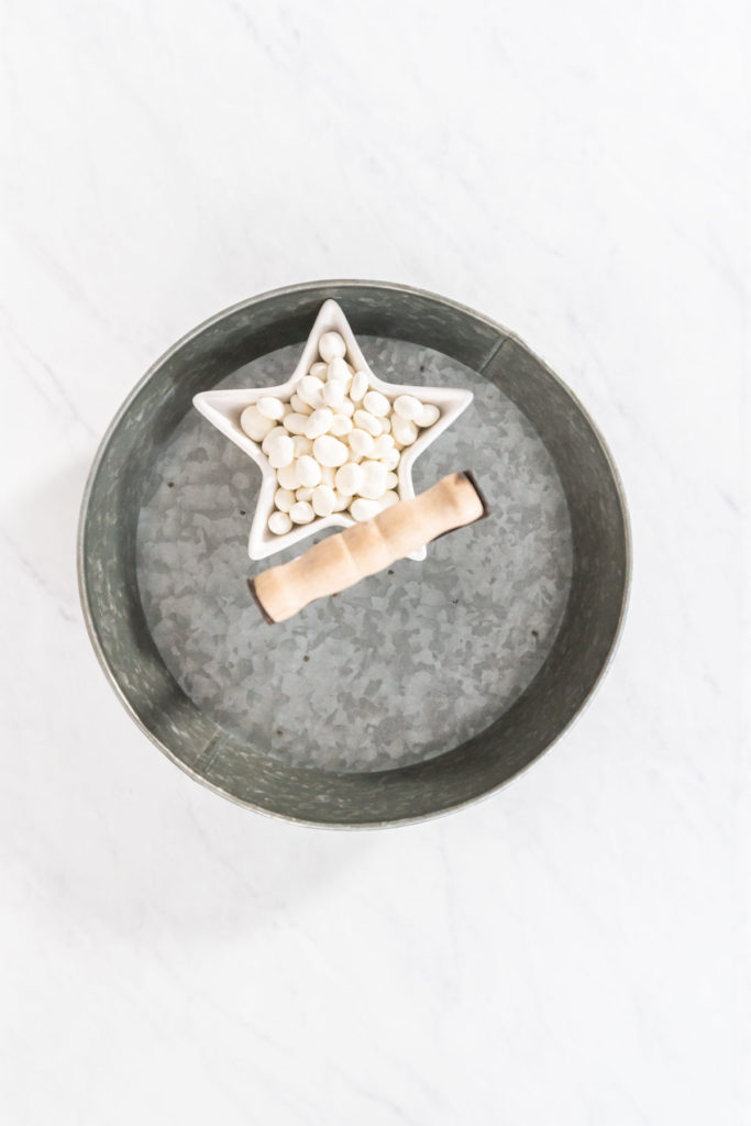 Mid-process image showing just white chocolate in a star bowl on the tra