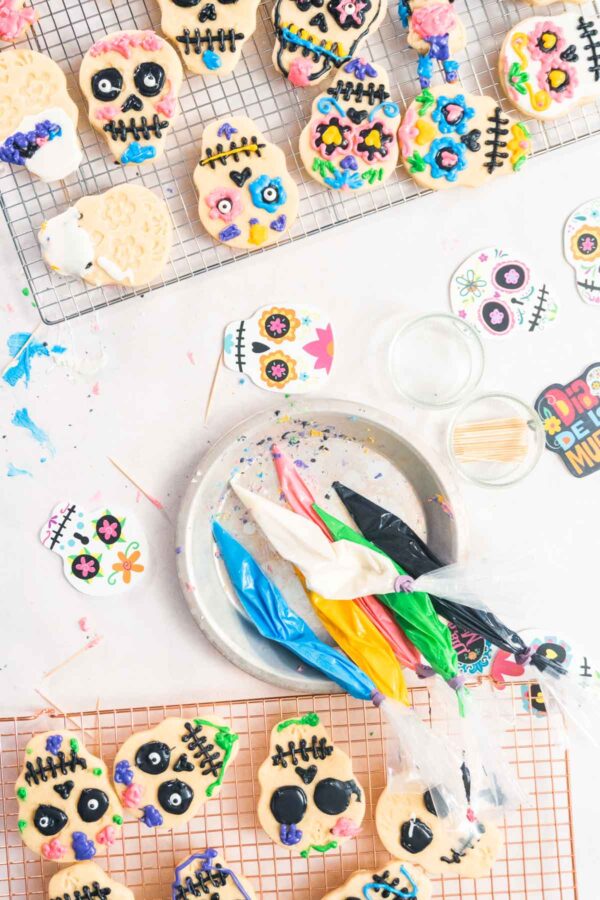 Sugar cookies - Arina Photography Top view. Decorating sugar cookies with Royal icing for Dia de los Muertos holiday.