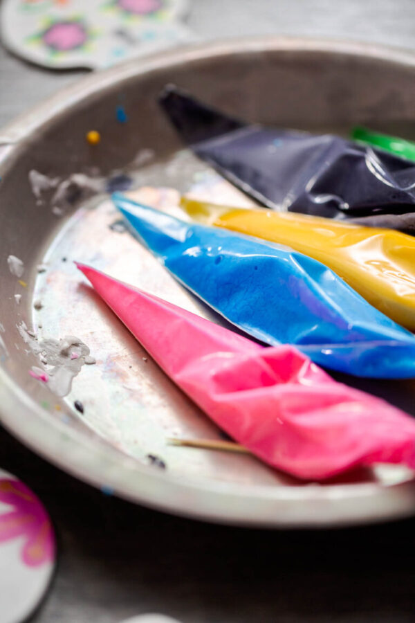 Sugar skull cookies - Arina Photography Piping bags with colorful royal icing to decorate sugar cookies.
