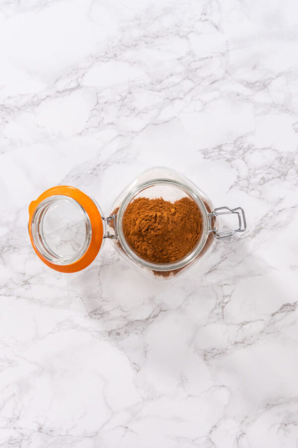 Flat lay. Preparing cinnamon sugar in a glass mason jar.