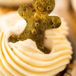 Freshly baked gingerbread cupcakes with eggnog buttercream frosting and topped with a gingerbread man.