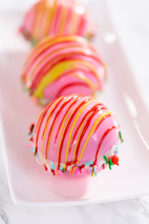 Christmas hot chocolate bombs on a white plate.