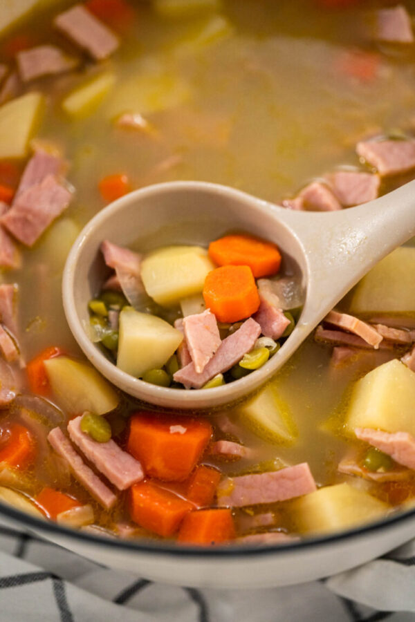 Serving split pea soup in ceramic soup bowls.