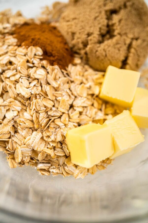 Mixing ingredients in a large glass mixing bowl to bake banana oatmeal muffins.