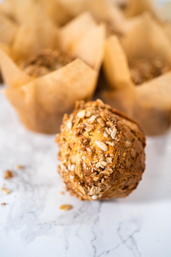 Freshly baked banana oatmeal muffins with oatmeal sugar topping.