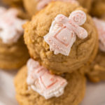 Pile of eggnog cookies with a chocolate gingerbread man in a stack.