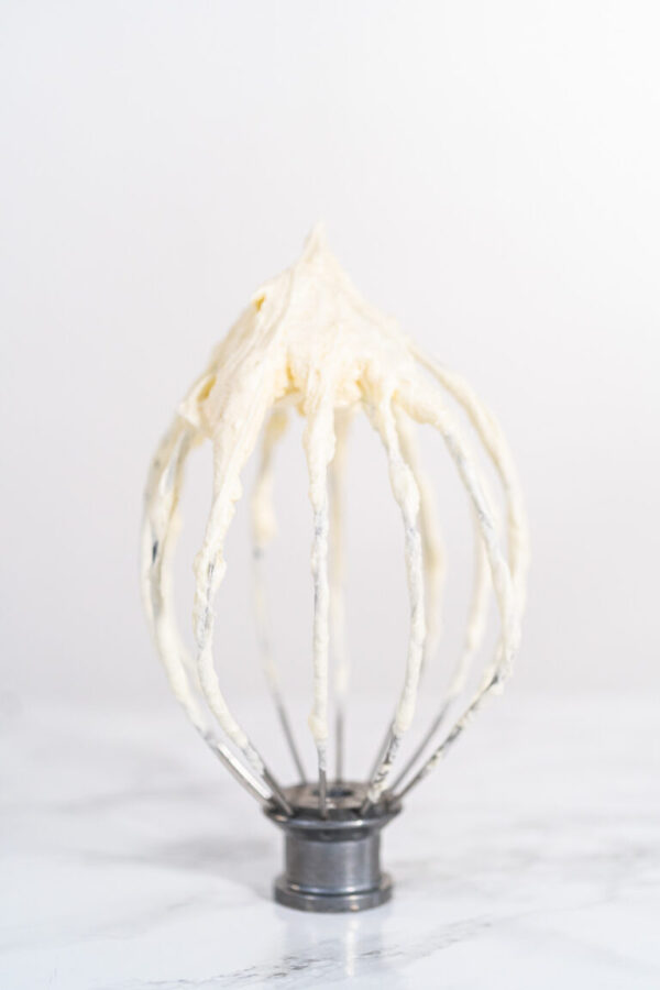 Whipping white ganache in kitchen mixer to make the white chocolate ganache frosting.