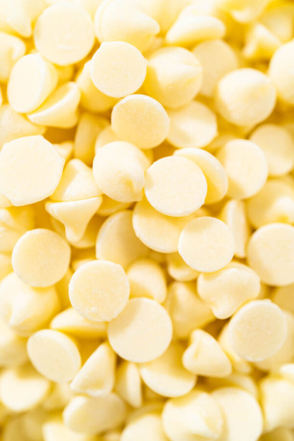 Measured ingredients in glass mixing bowls to make white chocolate ganache frosting.