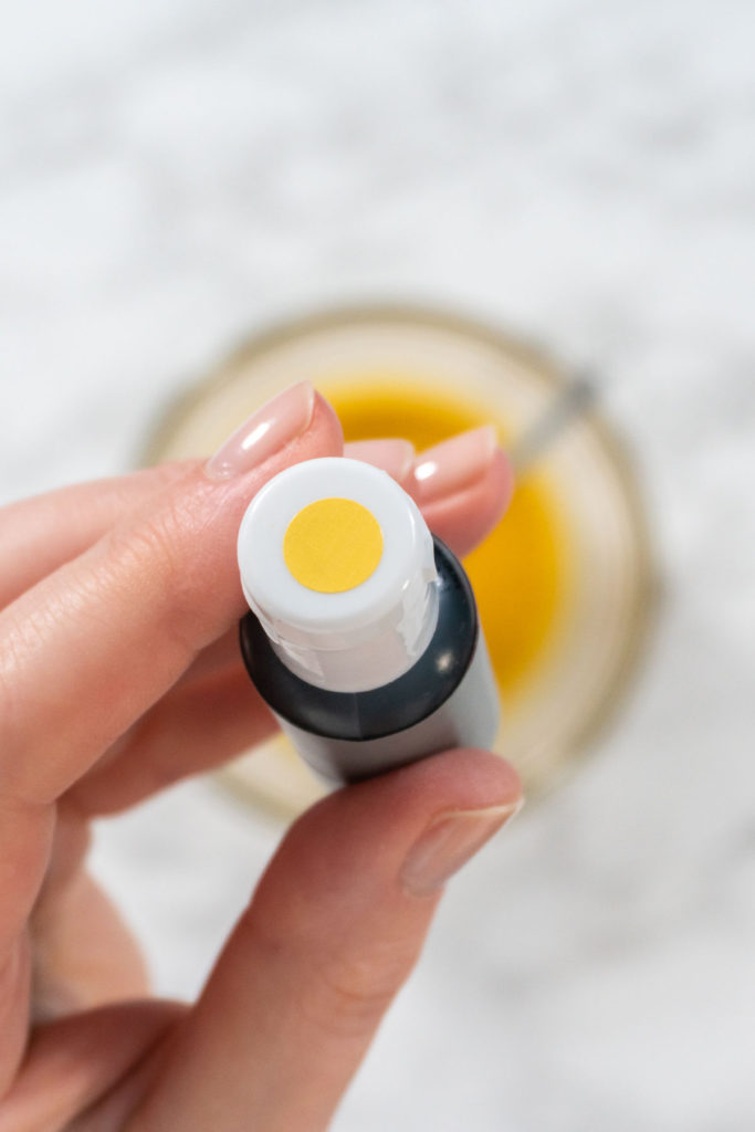 Yellow gel food coloring being squeezed from a bottle.