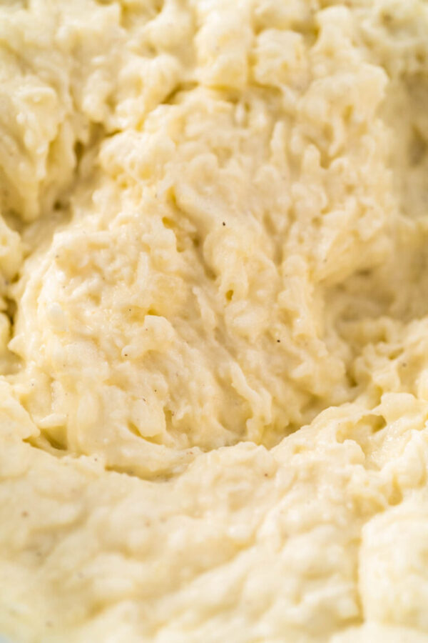 Mashed potatoes. Mashing cooked potatoes in a glass mixing bowl with a hand mixer made creamy mashed potatoes.
