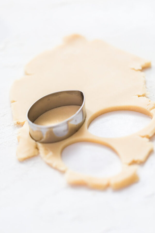 Sugar cookies - Arina Photography Cutting out shapes with metal cookie cutter out of the sugar cookie dough.