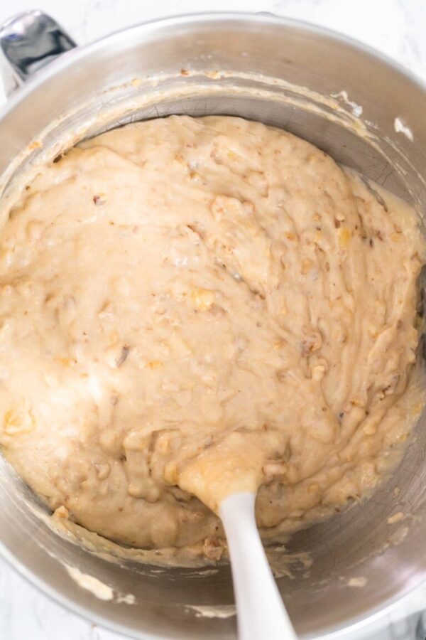 Banana nut bread batter in a metal mixing bowl.