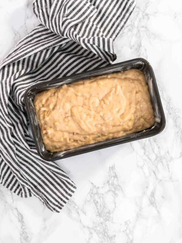Flat lay. Banana nut bread batter in the loaf pan before baking.