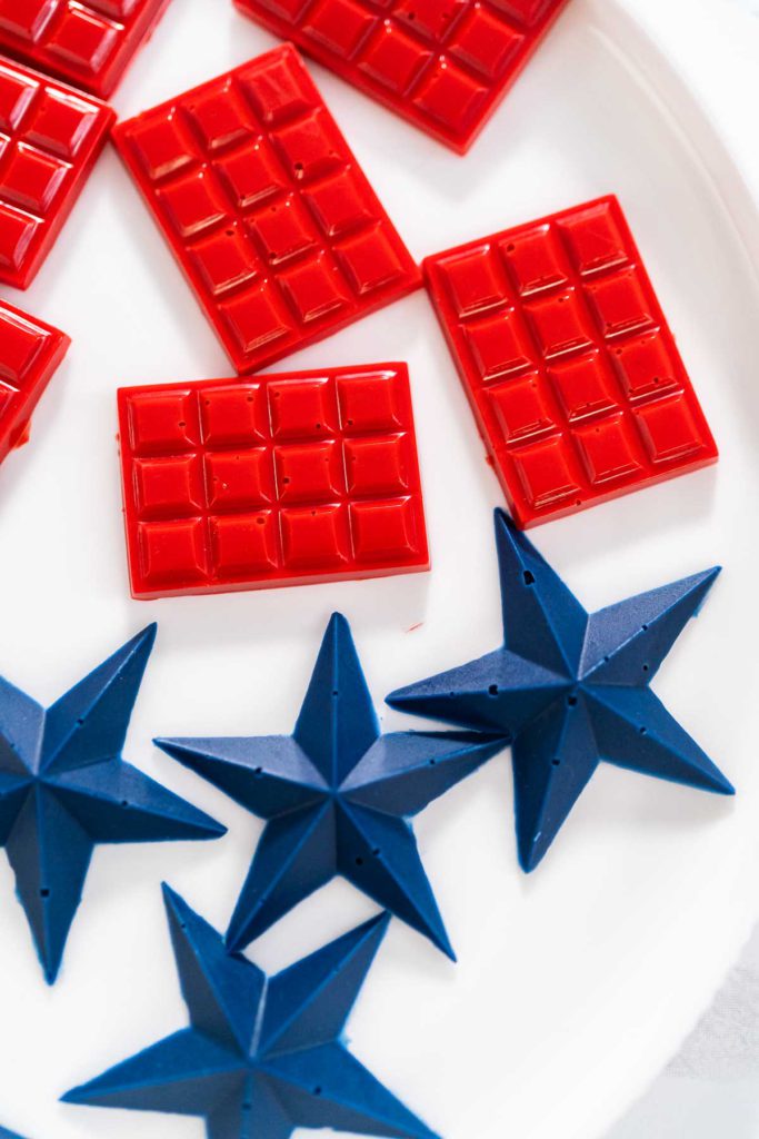 Close-up of red mini chocolate bars and blue star toppers made with silicone molds.
