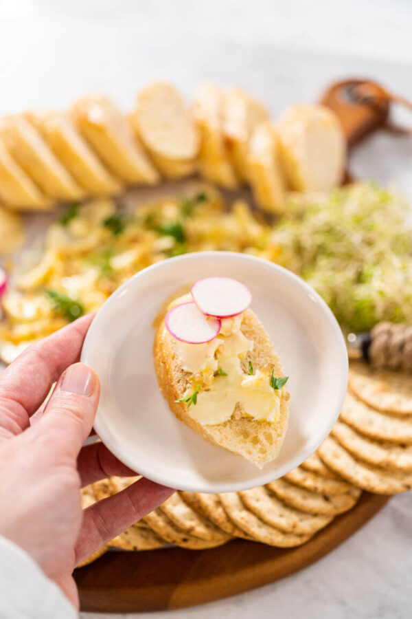 Slice the french baguette with flavored butter and radish.