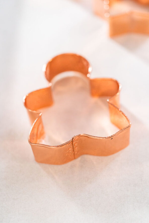Filling cookie cutter with fudge mixture to prepare Christmas cookie-cutter peppermint fudge.