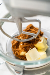 Butter and brown sugar in a stand mixer, ready to be creamed together for Vibrant Green Gingerbread Cookies for Festive Baking. This step creates a smooth, fluffy texture.