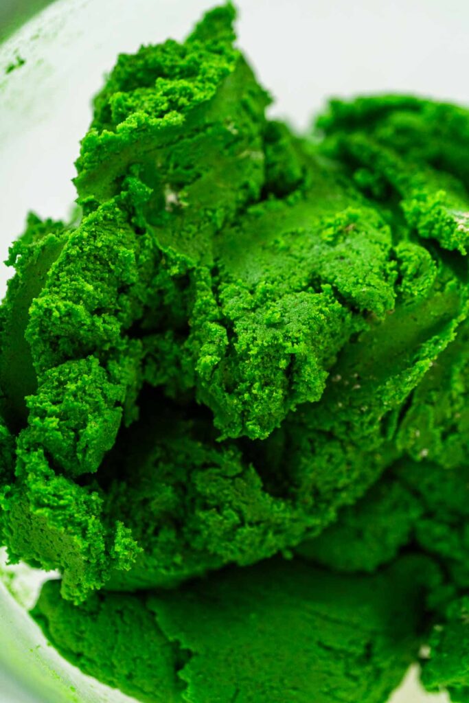 A close-up of the fully blended green dough, smooth and vibrant, for Vibrant Green Gingerbread Cookies for Festive Baking. The dough is ready for chilling and shaping.