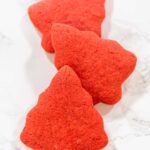 Festive Red Gingerbread Cookies for the Holidays - Arina Photography Three Red Gingerbread Cookies in Christmas tree shapes