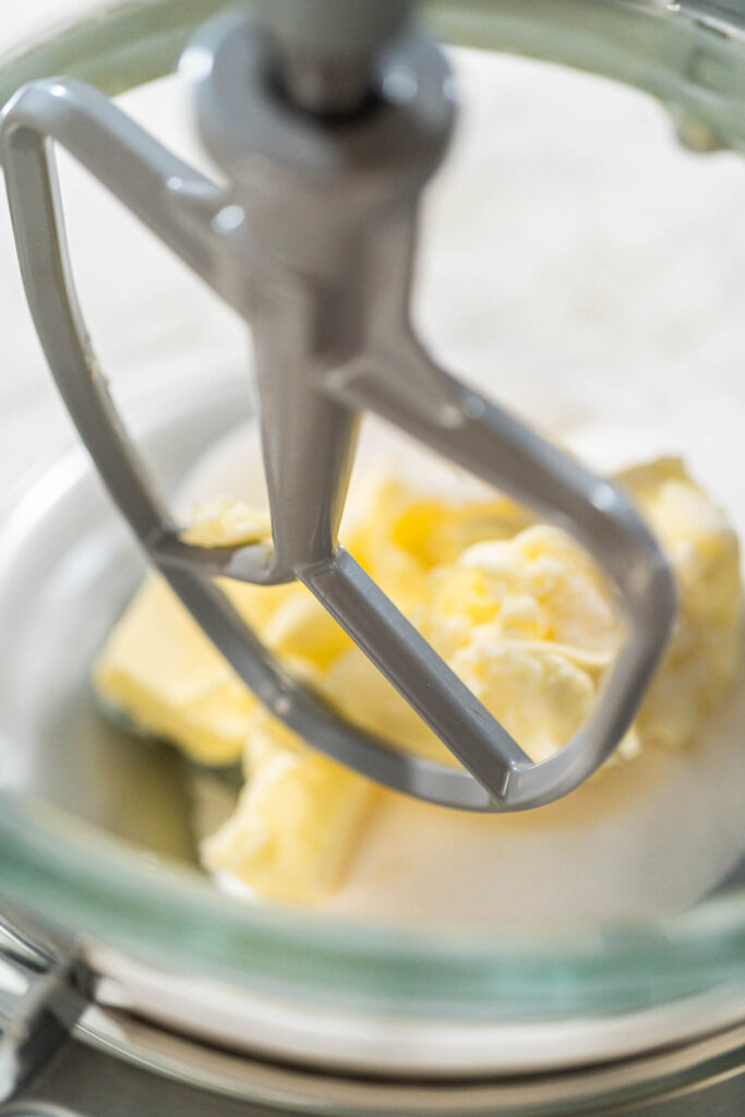 Close-up of a stand mixer creaming together butter and sugar for the Chocolate Ginger Sugar Cookie Dough, creating a light, fluffy base.