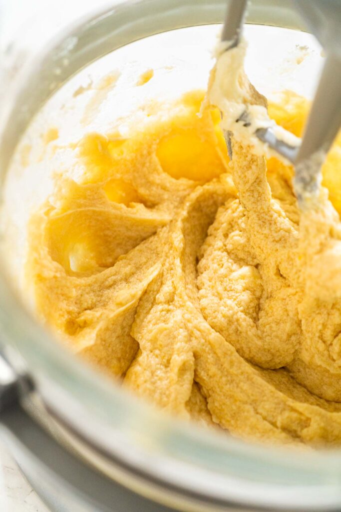 Mixing the wet ingredients to a smooth consistency for Chocolate Ginger Sugar Cookie Dough, showing the thickened, fluffy mixture in the stand mixer.