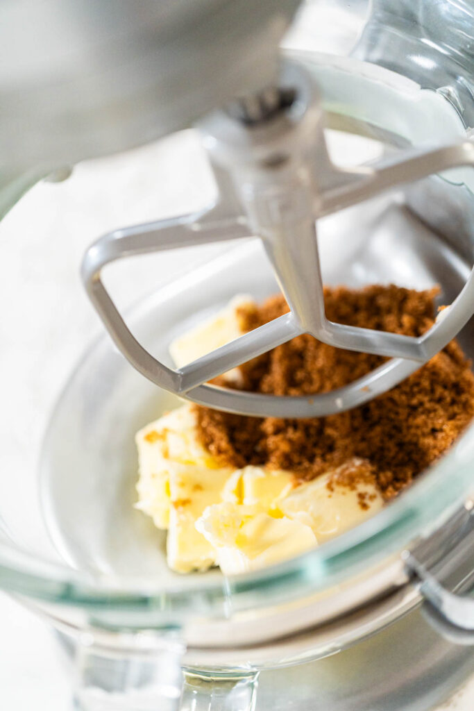 Stand mixer with a paddle attachment, poised to cream together butter and brown sugar for Spiced Gingerbread Cookie Dough Perfect for Baking. The ingredients are ready for the initial mixing stage of the dough preparation.