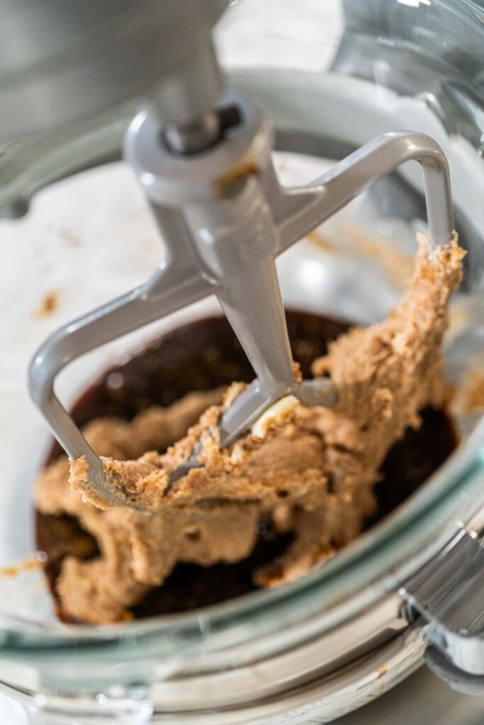 Butter and brown sugar creamed together in a stand mixer for Zesty Orange Gingerbread Cookie Dough. The mixture is light and fluffy, setting up the perfect texture for adding the molasses mixture.