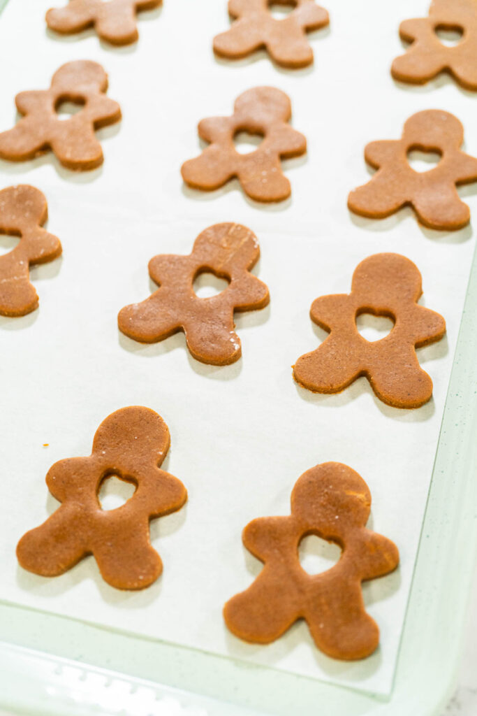 Preparing and Baking Classic Gingerbread Cookies in Gingerbread - Arina Photography Overhead view of gingerbread dough rolled out with flower and heart cookie cutouts.