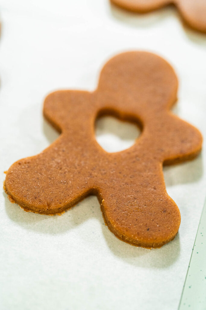 Preparing and Baking Classic Gingerbread Cookies in Gingerbread - Arina Photography Overhead view of gingerbread dough rolled out with flower and heart cookie cutouts.