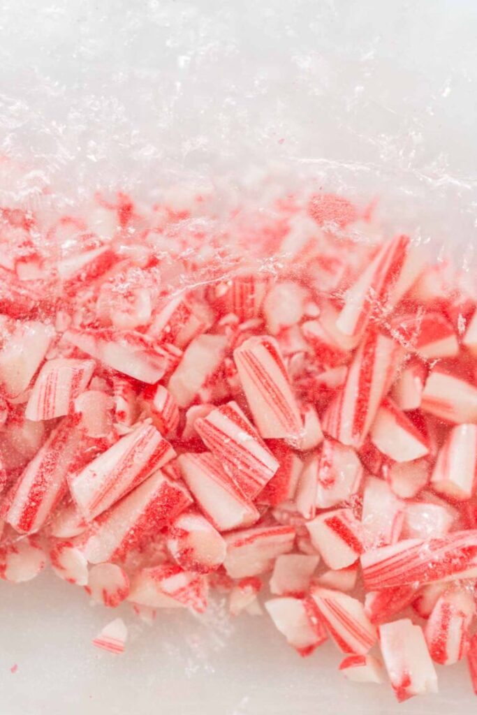 Close-up of crushed candy cane pieces inside a resealable plastic bag.