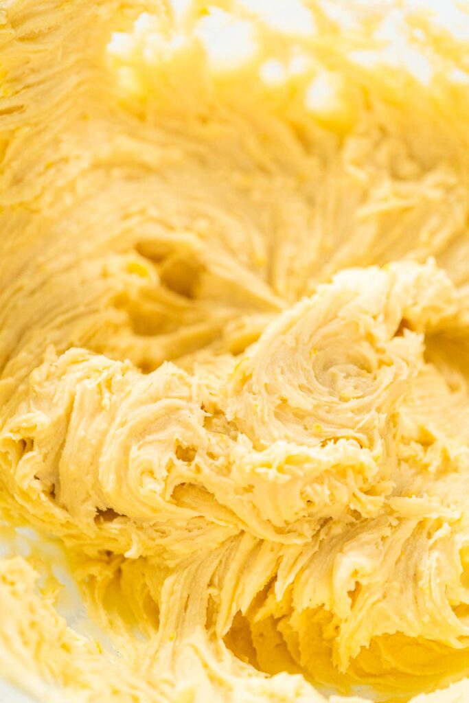 Close-up of soft, fluffy lemon spritz cookie dough after fully mixed and ready to load into the cookie press.